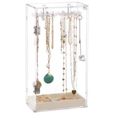 a clear display case with various necklaces hanging from it's sides and on the inside