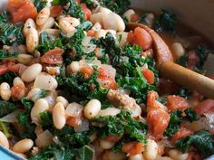 a blue pot filled with beans and greens