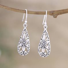 India's Ajay Patil brings us a tender design inspired by flowers and nature. These sterling silver dangle earrings feature little floral details enclosed in stylish teardrop formations. Spring Sterling Silver Dangle Jewelry, Spring Sterling Silver Earrings, Silver Dangle Flower Earrings For Spring, Sterling Silver Dangle Jewelry For Spring, Silver Drop Earrings For Spring, Elegant Silver Flower Earrings For Summer, Silver Teardrop Flower Earrings In Sterling Silver, Sterling Silver Teardrop Pierced Flower Earrings, Elegant Sterling Silver Earrings For Spring