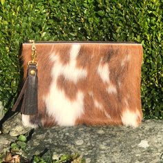 This is a beautiful Breccia clutch bag that is great for so many occasions, or for use everyday with style. Dimensions: Height: 18.5cm (7.3in) Width: 24cm (9.4in) Flat construction. The Breccia clutch is made from hair on cowhide in tricolour brown, black and white (sometimes with creamy yellow patches) with soft, brown leather on the back. Please choose from the drop down list should you want cowhide on both sides. The Breccia has a cotton, fawn lining with gold dots and a handy credit card siz Brown Handheld Clutch As Gift, Brown Handheld Clutch As A Gift, Brown Clutch Pouch With Zipper, Brown Handheld Clutch With Removable Pouch, Brown Pouch Clutch, Brown Clutch With Zipper Pouch As Gift, Brown Pouch Clutch As Gift, White Clutch Purse, Cowhide Clutch