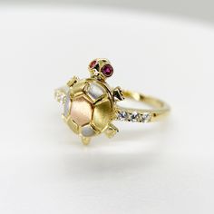 14k Solid Gold Turtle Tourmaline Tri Color Red Eye Moving Head Lucky CZ Ring for Women Girl * Metal : Real 14K Yellow Gold * Condition : Brand New * Finish : Polished * Height : 14.6 mm * Weight : 2.9 gram This is an approximate size & weight. Please expect up to ±10% difference. * Processing time : 1~2 business days * Ships from California This is 100% Authentic 14k Gold. Not plated or filled. All of our items are brand new and are shipped with a gift box. Gold Multi-stone Ruby Birthstone Ring, Gift White Gold Multi-stone Ruby Ring, Gift Yellow Gold Multi-stone Diamond Ring, Yellow Gold Multi-stone Diamond Ring Gift, Gift Multi-stone Ruby Ring In White Gold, Fine Gold Multi-stone Ruby Ring, Gift Ruby Ring In White Gold With Multi-stone, Fine Gold Ruby Ring With Multi-stones, Red Multi-stone Cubic Zirconia Jewelry