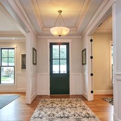 an empty entryway with a rug on the floor