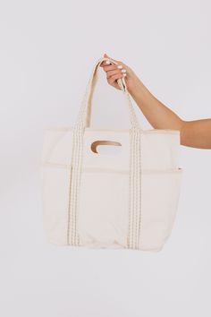 Ride the trend in this canvas tote bag from FREE PEOPLE! Perfect for carrying all your essentials (and more), this tote is stylish and functional. No need to pack lightly with this spacious and durable bag. Get in on the caravan craze now! Weekend Cotton Bag With Double Handles, Beige Canvas Bag With Reinforced Handles For Everyday Use, Weekend Canvas Bag With Pockets, Weekend Canvas Bag With Reinforced Handles, Weekend Canvas Tote Bag With Reinforced Handles, Weekender Tote Bag With Pockets, Weekend Tote Weekender Bag With Pockets, Weekend Canvas Bags With Pockets, Large Capacity Canvas Bag For Weekend