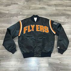 (eBay) Philadelphia Flyers Satin Starter Bomber Jacket Men’s Black Vintage Black Outerwear With Letter Print, Black Throwback Outerwear For College, Vintage Black Track Jacket With Pockets, Black Vintage Track Jacket With Pockets, Black Hooded Throwback Outerwear, Black Throwback Hooded Outerwear, Black Throwback Winter Outerwear, Black Winter Vintage Outerwear, Basic Wear