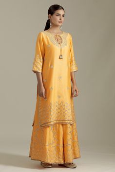 Mango chanderi silk kurta with gotapatti embroidered floral motifs and dori embroidery. Comes with sharara and dupatta.
Components: 3
Pattern: Embroidered
Type Of Work: Gota patti
Neckline: Keyhole
Sleeve Type: Three quarter
Fabric: Chanderi Silk,Net
Color: Yellow
Other Details: 
Tasselled tie detail
Attached lining
Closure: Sharara: Elasticated waistband
Occasion: Mehendi and Haldi,Sangeet - Aza Fashions Semi-stitched Raw Silk Set With Gota Work, Designer Raw Silk Sharara With Gota Work, Transitional Raw Silk Sharara With Zari Work, Diwali Raw Silk Palazzo Set With Zari Work, Semi-stitched Raw Silk Sharara With Zari Work, Art Silk Sharara With Dori Work For Festive Occasions, Festive Art Silk Sharara With Dori Work, Navratri Slub Silk Sets With Dori Work, Festive Tissue Silk Sharara With Gota Work