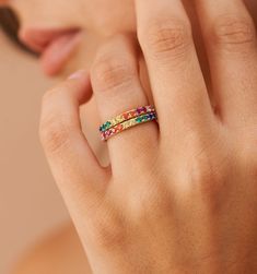 Meet our Rainbow Band Ring- this whimsical piece is adorned with an arc of meticulously selected CZ stones, each shimmering with the joyous hues of the rainbow. Perfect for the color-loving daydreamer, this ring is more than an accessory—it's your very own piece of wearable joy. Multicolor Jewelry As A Gift, Adjustable Rainbow Stackable Jewelry, Adjustable Rainbow Gemstone Ring, Adjustable Multi-stone Rainbow Jewelry, Adjustable Rainbow Birthstone Jewelry, Elegant Adjustable Rainbow Rings, Fine Jewelry: Multicolor Stackable Pieces, Multicolor Halo Rings As A Gift, Rainbow Cubic Zirconia Jewelry With Sparkling Stones