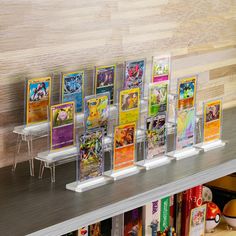 a display case filled with lots of cards on top of a wooden shelf next to a wall