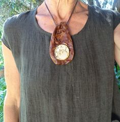 "Large wood stone necklace in fully adjustable length.  Earthy, primitive jewelry handmade from eucalyptus wood with a magical Yowah nut inlaid. The Yowah nut is filled with silicified clay and calcite framed by Ironstone. A wonder piece of nature held & embrace by the amazing wood. The texture of the face in the wood is natural, the back is black as the tree went through a wild fire. Such an amazing piece. It invites to be touched, held and cuddled ... being a companion along your path. Wear th Adjustable Natural Wood Necklace Nature-inspired, Natural Carved Nature-inspired Necklace, Nature-inspired Necklace With Large Stone, Nature-inspired Carved Natural Necklace, Nature-inspired Jewelry With Natural Stones, Unique Earth-toned Necklaces With Natural Stones, Nature-inspired Natural Stones Jewelry, Unique Natural Stone Necklace, Adjustable Nature-inspired Necklaces With Natural Variations