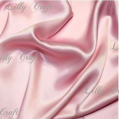 a pink satin fabric with the word lilly craft on it