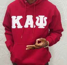 Exclusive Kappa Alpha Psi Double Stitched Appliqué Embroidery Lettered Hoodie. This is the perfect long-sleeved hoodie to wear while showing off your Kappa Alpha Psi fraternity lettering. A comfortable 100% cotton tee with a twill Greek letters embroidery across the chest give you the perfect fit. This hoodie is also a perfect gift for your favorite Kappa Man. Fast Shipping & Processing: 1-2 days to process US Domestic Shipping: 3-5 business days International Shipping: 7-14 business Collegiate Sweatshirt With Drawstring Hood For Fall, Collegiate Fall Sweatshirt With Drawstring Hood, Collegiate Long Sleeve Fleece Hoodie, Streetwear Long Sleeve Hoodie With Letter Embroidery, Long Sleeve Hoodie With Letter Embroidery For Streetwear, Collegiate Style Long Sleeve Spring Sweatshirt, Varsity Long Sleeve Fleece Hoodie, Varsity Style Long Sleeve Fleece Hoodie, Hooded Tops With Letter Embroidery For Winter