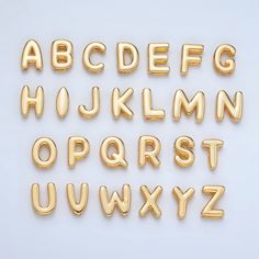 the letters and numbers are made out of gold balloon type balloons, which have been placed on top of each other