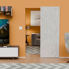 a living room with an orange wall and a television on the stand in front of it