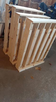 some wooden boards are stacked on top of each other in a room with construction equipment