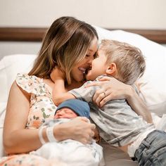 a mother and son cuddling on a bed