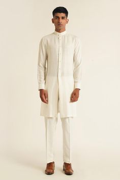 Ivory silk open bandhgala with overlap lapel panel and tonal French knot thread embroidery. Paired with plain full sleeves kurta and straight fit pyjama.
Components: 3
Pattern: Embroidered
Type Of Work: French Knot Thread Work
Neckline: Bandhgala: Lapel Collar, Kurta: Band Collar
Sleeve Type: Full Sleeves
Fabric: Silk
Color: Ivory
Other Details: 
Side slits
Kurta Closure: Front button placket
Occasion: Cocktail and Reception,Destination Wedding - Aza Fashions Elegant White Formal Kurta, Elegant Off White Kurta For Ceremonial Occasions, Classic Cream Bandhgala For Festive Occasions, Elegant Off White Ceremonial Kurta, Classic White Sherwani For Festive Occasions, Formal Off White Sets With Traditional Drape, Formal Off White Set With Traditional Drape, Elegant White Nehru Jacket For Transitional Season, Designer Cream Kurta For Formal Occasions