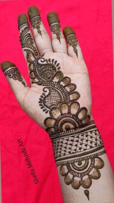 a hand with henna tattoos on it