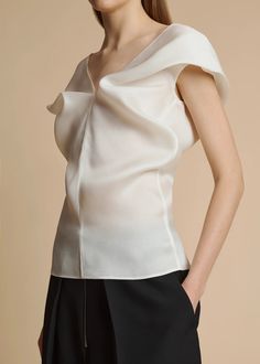 The Ami Top in Chalk– KHAITE Luxury Sleeveless Tops For Evening, Spring Evening Top With Structured Shoulders, Silk Top With Asymmetrical Neckline For Party, Silk Top With Asymmetrical Neckline For Evening, Chic Evening Top With Wide Neckline, Chic Evening Tops With Open Neckline, Elegant Blouse With Structured Shoulders For Party, Elegant Party Blouse With Structured Shoulders, Elegant Evening Blouse With Structured Shoulders