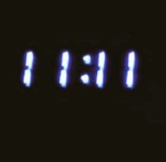 an image of the time displayed on a clock in the dark with blue light coming from it