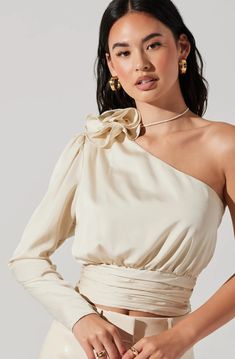 Front view of woman wearing a champagne color satin one shoulder long sleeve top with a corsage detail at the top shoulder Shoulder Corsage, Floral Corsage, Satin Top, Asymmetrical Tops, Champagne Color, One Shoulder Tops, Dressy Tops, Shoulder Design, Hem Dress