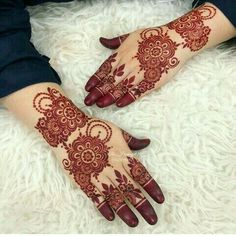 two hands with henna designs on them