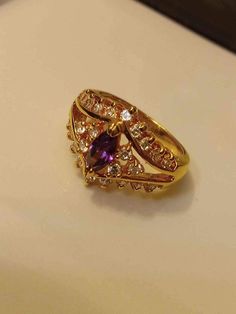 etails Condition New Color Purple Gemstone Amethyst Age Group All Ages Material Gold 14k Solid Yellow Gold Amethyst Statement Ring with Unknown Clear Gemstones Size 7.5 Gold Gemstones Ring With Gemstone Accents, Multi-stone Amethyst Ring In Yellow Gold, Yellow Gold Crystal Ring With Stone Setting, Gold Amethyst Ring For Wedding, Fine Jewelry, Exquisite Yellow Gold Amethyst Ring With Accent Stones, Heirloom Amethyst Ring With Diamond In Gold, Heirloom Gold Amethyst Ring With Diamond, Fine Jewelry Amethyst Gold Ring, Gold Marquise Amethyst Ring