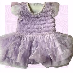 Fao Lavender Layered Tulle Dress, Matching Diaper Cover. Lavender Tulle Dress With Ruffles, Purple Tulle Dress With Ruffles, Fitted Ruffle Fairy Dress For Dress-up, Fitted Fairy Dress With Ruffles For Dress-up, Lavender Fitted Princess Dress For Dress-up, Lavender Princess Dress With Ruffles, Sleeveless Purple Fairy Dress With Ruffles, Purple Sleeveless Fairy Dress With Ruffles, Fitted Ruffled Tutu Dress For Playtime