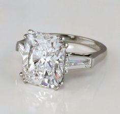 a cushion cut diamond ring with baguettes on the sides