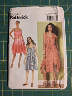 a woman's dress and top sewing pattern on a cutting board