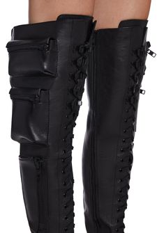 These thigh high combat boots have a vegan leather construction, heeled platform soles, zippered pockets on the sides, buckle strap details, adjustable lace-ups, and side zip closures. Boots With Pockets, Thigh High Combat Boots, How To Wear Thigh High Boots, High Combat Boots, Combat Clothing, Combat Clothes, Current Mood Clothing, Black Thigh High Boots, Leather Thigh High Boots