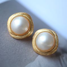 --- SPECIFICS --- 💚Materials: 100% Natural High Quality Mabe Pearl With 24k gold plated s925 Sterling silver 💚-The Mabe Pearl is 100% natural UNTREATED , UNHEATED, UNDYED Mabe Pearl- 💚Metal: Real 24k Gold plated s925 Sterling Silver 💚Pearl Diameter: 12mm*12mm 💚Closure: the closure is made of 925 Sterling Silver.  💚Handmade Artwork, original design and copyright protected💚 These stunning gold plated silver earrings feature a beautiful pair of hemisphere Mabe Pearl stones. With their intric Fake Mabe Pearl Earrings, Classic White Gold Clip-on Earrings For Formal Occasions, Classic White Gold Clip-on Earrings For Anniversary, Classic Bridal Earrings With Elegant Design For Evening, Classic Elegant Design Bridal Earrings For Evening, Classic Elegant Bridal Earrings For Evening, Luxury Clip-on Bridal Earrings For Anniversary, Exquisite Gold Clip-on Earrings, Classic White Gold Clip-on Earrings