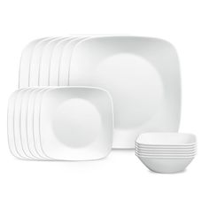 white dishes are stacked on top of each other