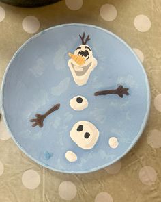 a plate that has some kind of frozen snowman on it with googly eyes