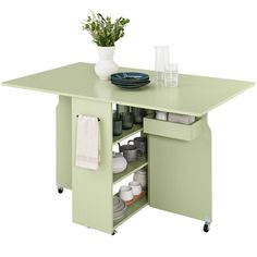 a kitchen island with two drawers and an open shelf on the side, in light green