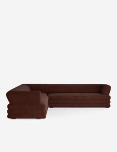 a brown sectional couch sitting on top of a white floor