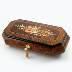 an ornately decorated wooden box with tassels