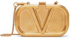 Sculptural shoulder bag in antiqued gold-tone featuring logo embossed at face. · Detachable curb chain shoulder strap · Tab-slot fastening · Grained leather lining in red · H3 x W5 x D1 in Supplier color: Antique brass | Valentino Garavani Gold Mini VLogo Shoulder Bag Gold Bag, Fancy Bags, Valentino Women, Reversible Belt, Valentino Bags, Curb Chain, Clutch Handbag, Valentino Garavani, Antique Gold