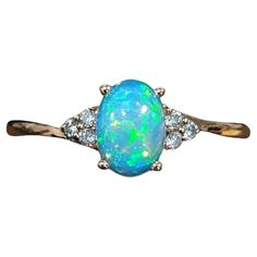 This lovely opal has all the colors of the rainbow, accented with natural earth mined diamonds set in 14k yellow gold. An elegant bypass ring design makes this glowing ring perfect for the modern bride or that special someone in your life! This opal ring also makes a beautiful October birthstone gift for your loved ones! Specifications Item type: Ring Center Stone: Opal Treatment: None Weight: 0.69ct Head size: 7x5mm Shape: Oval Hardness: 5-6.5 Origin: Ethiopia Metal: 14k/1.65g Diamond Clarity/C Lightning Ridge Black Opal, Opal Diamond Ring, White Opal Ring, Bypass Ring, Opal Engagement, Vs Diamond, Gold Ring Stack, Green Opal, Opal Earrings