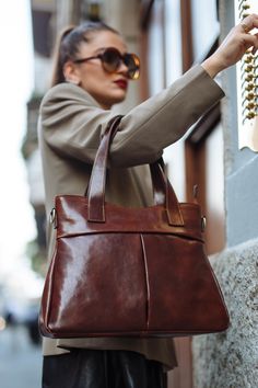 "This Brown cowhide leather bag is 100% handmade. this large tote bag is suitable for carrying everything in your everyday life. It has a Zipper Closure and Cross-Body strap. The bag has a cotton lining and it has 3 inner pockets. as you can see it made by really high-quality Italian leather.this leather calls \"Pelle Conciata Al Vegetale\", which means that the leather is tanned with only natural materials. Dimentions: - Width ( top of the bag ) : 32 Cm / 12.5'' ( Bottom of the bag ) : 37 Cm / Brown Double Handle Shoulder Bag For Everyday, Brown Leather Bucket Bag With Top Carry Handle, Brown Leather Bucket Bag With Top Handle, Brown Top Handle Shoulder Bag For Everyday, Brown Everyday Top Handle Shoulder Bag, Everyday Brown Top Handle Shoulder Bag, Brown Soft Leather Shoulder Bag With Double Handle, Leather Lined Satchel Bag For Shopping, Leather-lined Satchel Bag For Shopping