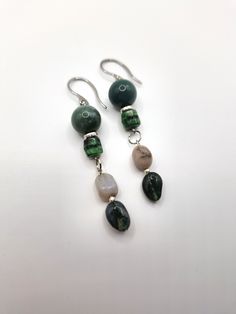 Earthy forest-inspired gemstone earrings; crafted with Indian agate stone pebbles, polished deep green agate stone, and mossy colored Czech glass beading. *Handmade by me, one of a kind. *Length: 7.2 cm *Diameter of green agate: 12 mm *Crafted with silver stainless steel hypoallergenic hooks.  Nickel free. Click on the link below if you would like to see more artisan jewelry and unique artwork! https://www.etsy.com/shop/CailinCreatesCo I try my best to accurately portray the details in all of my jewelry. Please note that colors may vary due to lighting conditions, camera settings, and variations in computer monitor or phone display settings. If you have any questions regarding any items I have available, please do not be afraid to reach out! Bohemian Agate Earrings, Bohemian Agate Earrings With Natural Stones, Bohemian Agate Earrings For Gift, Bohemian Agate Earrings Gift, Bohemian Moss Agate Gemstone Jewelry, Green Moss Agate Bohemian Jewelry, Bohemian Moss Agate Jewelry, Green Bohemian Moss Agate Jewelry, Handmade Bohemian Jade Jewelry