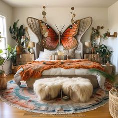 a bedroom with a large bed covered in lots of butterflies on the wall above it