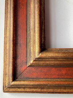 an old wooden frame hanging on the wall