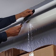 a man is working on an air conditioner