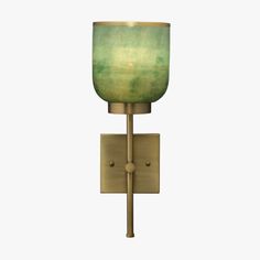 a wall light with a green glass shade on the top and bottom half of it