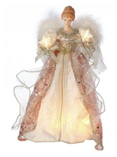 an angel figurine with white wings and stars on it's chest is lit up