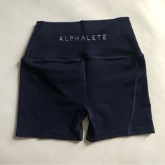 Alphalete High Rise Revival Shorts, Size Small. Navy Blue. New Condition, Never Worn. Squat Proof. Activewear / Gym Wear, Also Cute Worn Casually. Tag Size - Small Brand - Alphalete Condition - Brand New Waist 12” Inseam 4” #Alphalete #Shorts #Small #Revival #Highrise Blue Stretch Activewear With Letter Print, Blue Letter Print Activewear For Summer, High Waist Blue Training Shorts, High Waisted Blue Shorts For Training, Fitted Sports Shorts With Letter Print, High Waist Blue Shorts For Training, Blue Bottoms With Letter Print, Short Length, Blue Letter Print Shorts, Blue Workout Activewear With Letter Print