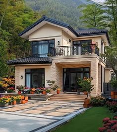 a large house with lots of flowers in the front yard