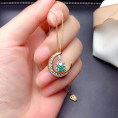 Gorgeous and delicate Green Moissanite necklace ， Nice gift for girlfriend/wife or Mother It will come with GRA Certificates， So please Don't worry about quality， Every stone is The Best！ Basic information Stone： Top grade Green Moissanite Color Grade：D color Clarity Grade ： VVS Stone Shape: Circle 6.5 mm Stone weight ： 1.0 ct Metal Materials: Sterling Silver Cut Grade ： Excellent Green Necklace With Moon Charm, Green Moon Charm Round Necklace, Green Moon Charm Necklace, Round Cubic Zirconia Emerald Necklace Gift, Gift Round Emerald Cubic Zirconia Necklace, Gold Moissanite Jewelry For May Birthstone, Promise Jewelry, Green Moissanite, Shape Circle