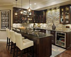 a kitchen with marble counter tops and dark wood cabinets, along with bar stools