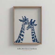 two giraffes standing next to each other in a wooden frame on the wall