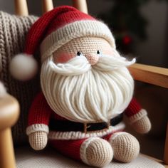 a knitted santa clause doll sitting on a chair